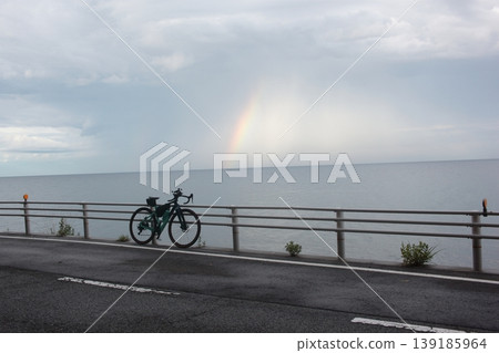 A beautiful landscape of Sado Island and a bicycle, a miraculous moment adorned with a faint rainbow. A beautiful landscape of Sado Island and a bicycle, a miraculous moment adorned with a faint rainbow. 139185964