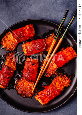 Bacon roll with enoki mushroom grilled with sauce. Bacon roll with enoki mushroom grilled with sauce. 139186417