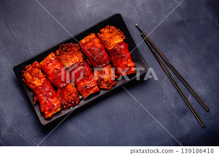 Bacon roll with enoki mushroom grilled with sauce. Bacon roll with enoki mushroom grilled with sauce. 139186418