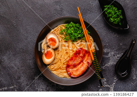 A bowl of ramen with noodles, meat and green onions. A bowl of ramen with noodles, meat and green onions. 139186427