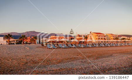 Sunset over beachfront resort with loungers Sunset over beachfront resort with loungers 139186447
