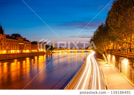 View of Paris by night with the Seine river and the Conciergerie building View of Paris by night with the Seine river and the Conciergerie building 139186491