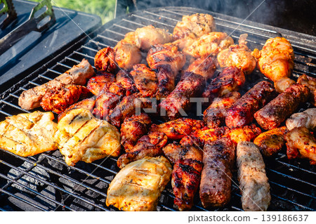 grilled meat over the coals on barbecue grilled meat over the coals on barbecue 139186637