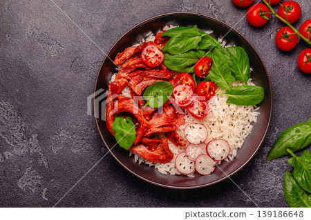 Bowl with vegan fried soy meat and vegetables served with boiled rice. Bowl with vegan fried soy meat and vegetables served with boiled rice. 139186648