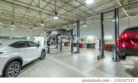 Cars moves on lifts in modern service station and men repair cars timelapse hyperlapse. Cars moves on lifts in modern service station and men repair cars timelapse hyperlapse. 139187317