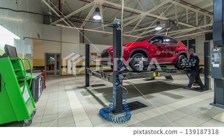 Car on stand with sensors on wheels for wheels alignment camber check in workshop of Service station timelapse. 139187318