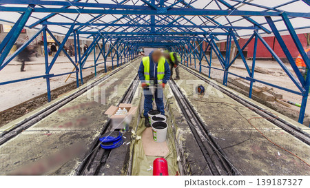 Tram rails at the stage of their installation and integration into concrete plates on the road timelapse. 139187327