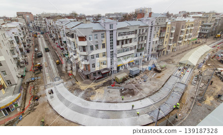 Covering concrete for road maintenance construction site with many workers and mixer timelapse 139187328