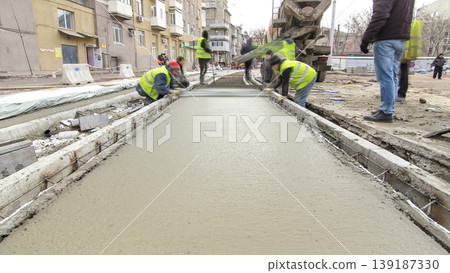 Pouring ready-mixed concrete after placing steel reinforcement to make the road by concrete mixer timelapse hyperlapse. Pouring ready-mixed concrete after placing steel reinforcement to make the road by concrete mixer timelapse hyperlapse. 139187330