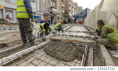 Pouring ready-mixed concrete after placing steel reinforcement to make the road by concrete mixer timelapse hyperlapse. Pouring ready-mixed concrete after placing steel reinforcement to make the road by concrete mixer timelapse hyperlapse. 139187332