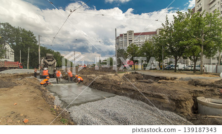 Concrete works for road maintenance construction with many workers and mixer timelapse 139187343