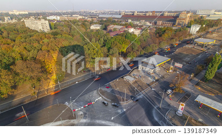 Construction site of avenue with asphalt paver, roller and truck aerial timelapse. Construction site of avenue with asphalt paver, roller and truck aerial timelapse. 139187349