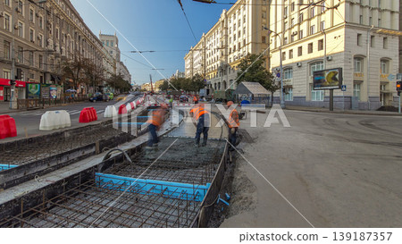 Concrete works for road maintenance construction with many workers and mixer machine timelapse 139187357