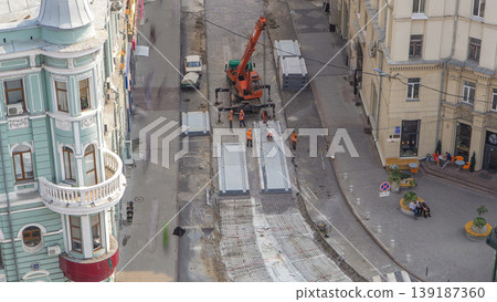 Installing concrete plates by crane at road construction site timelapse. 139187360