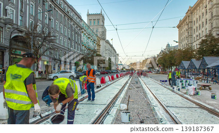 Tram rails at the stage of their installation and integration into concrete plates on the road timelapse. Tram rails at the stage of their installation and integration into concrete plates on the road timelapse. 139187367