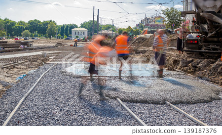 Concrete works for road construction with many workers and mixer timelapse 139187376