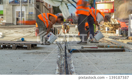 Tram rails at the stage of their installation and integration into concrete plates on the road timelapse Tram rails at the stage of their installation and integration into concrete plates on the road timelapse 139187387