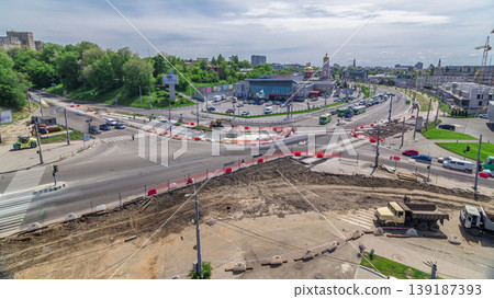 Aerial view of a large city intersection with road construction site urban works timelapse. 139187393