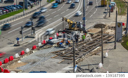 Installing concrete plates by crane at road construction site timelapse. Installing concrete plates by crane at road construction site timelapse. 139187395