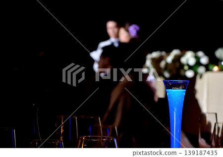 The reception hall was striking with its blue candles. 139187435
