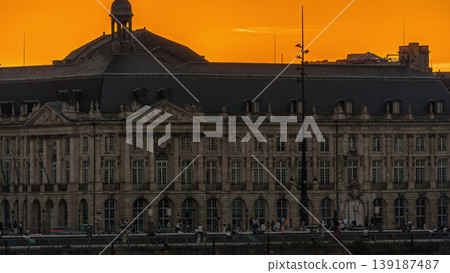 Sunset view of Bordeaux city skyline featuring spires and rooftops on a waterfront. Sunset view of Bordeaux city skyline featuring spires and rooftops on a waterfront. 139187487