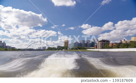Astana, Kazakhstan. View from Pleasure boat on the river Ishim timelapse hyperlapse drivelapse in Astana. Astana, Kazakhstan. View from Pleasure boat on the river Ishim timelapse hyperlapse drivelapse in Astana. 139187609