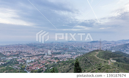 Barcelona and Badalona skyline with roofs of houses and sea on the horizon at evening timelapse Barcelona and Badalona skyline with roofs of houses and sea on the horizon at evening timelapse 139187674