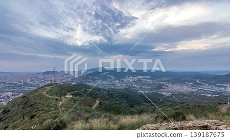 Barcelona and Badalona skyline with roofs of houses and sea on the horizon at evening timelapse Barcelona and Badalona skyline with roofs of houses and sea on the horizon at evening timelapse 139187675