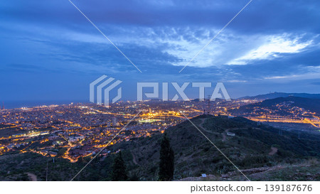 Barcelona and Badalona skyline with roofs of houses and sea on the horizon day to night timelapse Barcelona and Badalona skyline with roofs of houses and sea on the horizon day to night timelapse 139187676