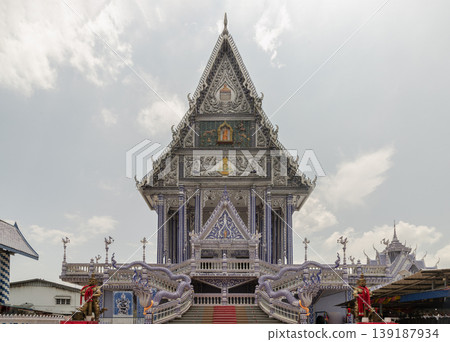 An architectural masterpiece, Wat Paknam Kham Nu often called Chanthaburi "Blue Temple" is renowned for its ethereal sapphire glow. Clad entirely in blue and white ceramic tiles, its porcelain-like An architectural masterpiece, Wat Paknam Kham Nu often called Chanthaburi "Blue Temple" is renowned for its ethereal sapphire glow. Clad entirely in blue and white ceramic tiles, its porcelain-like 139187934
