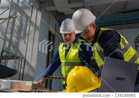 Construction workers collaborate on project industrial site photography indoor environment close-up view teamwork in action 139188065
