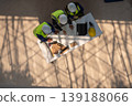 Construction planning meetings industrial setting professional discussion collaborative environment aerial view teamwork strategy 139188066