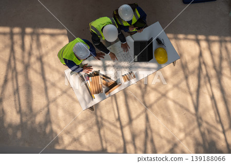 Construction planning meetings industrial setting professional discussion collaborative environment aerial view teamwork strategy 139188066