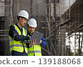 Construction workers collaborate on project plans at a building site industry action urban environment professional viewpoint 139188068