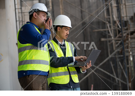 Construction site workers collaborate on project planning urban location business environment professional viewpoint teamwork concept Construction site workers collaborate on project planning urban location business environment professional viewpoint teamwork concept 139188069