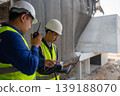 Construction workers collaborate on site urban construction zone engineering process daytime close-up teamwork in action 139188070