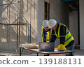 Construction team collaborating on project plans in urban setting professional environment overhead view teamwork concept 139188131