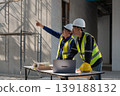 Construction site meeting between engineers urban area professional collaboration indoor environment side view project planning 139188132