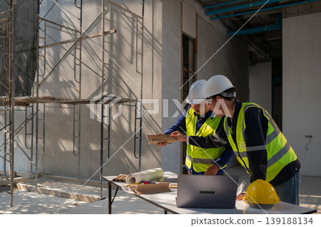 Construction project meeting interior site professional collaboration urban environment close-up view teamwork in action Construction project meeting interior site professional collaboration urban environment close-up view teamwork in action 139188134