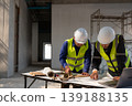 Construction team collaborating on project plans at a building site office environment professional perspective for efficiency 139188135