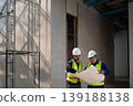 Construction workers analyzing blueprints building site professional collaboration indoor environment focused perspective project planning 139188138