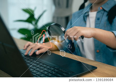 Young Child Examining Laptop With Magnifying Glass, Safeguarding Digital Data, Cybersecurity Awareness, Alerts and Notifications Displayed on Screen Young Child Examining Laptop With Magnifying Glass, Safeguarding Digital Data, Cybersecurity Awareness, Alerts and Notifications Displayed on Screen 139189084