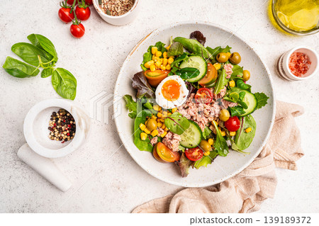 Tuna salad with tomatoes , olives , eggs and onion . Tuna salad with tomatoes , olives , eggs and onion . 139189372
