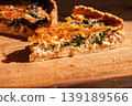 Close-up of a slice of French quiche on a wooden board, delicious traditional pastries in bright sunlight from a window, delicious homemade pastries 139189566