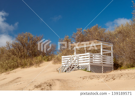bungalow on a sand dune near the beach, concept of a vacation invitation to secluded Mediterranean beaches, copy space for text 139189571