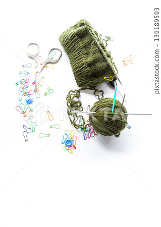 Knitted item with a wool ball and knitting accessories Knitted item with a wool ball and knitting accessories 139189593