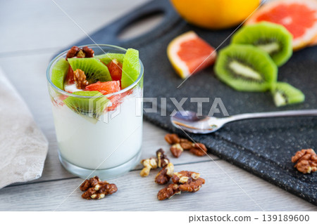 healthy breakfast yogurt with fresh fruits and nuts in glass healthy breakfast yogurt with fresh fruits and nuts in glass 139189600