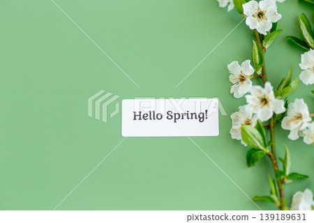 hello spring card with cherry blossoms on green background hello spring card with cherry blossoms on green background 139189631