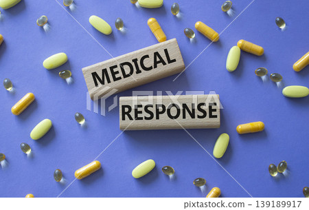 Medical response symbol. Concept word Medical response on wooden blocks. Beautiful purple background with pills. Medicine and Medical response. Copy space Medical response symbol. Concept word Medical response on wooden blocks. Beautiful purple background with pills. Medicine and Medical response. Copy space 139189917
