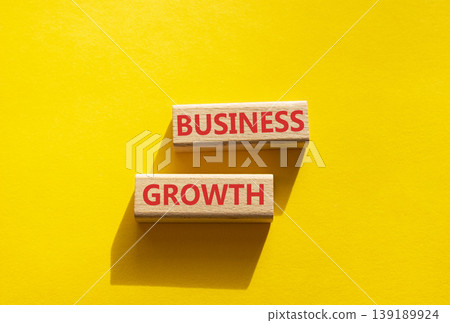 Business growth symbol. Concept word Business growth on wooden blocks. Beautiful yellow background. Business and Business growth concept. Copy space Business growth symbol. Concept word Business growth on wooden blocks. Beautiful yellow background. Business and Business growth concept. Copy space 139189924
